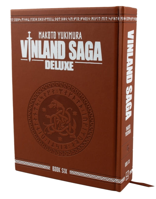 Vinland Saga Deluxe 6 hardcover book with a brown cover and embossed design.
