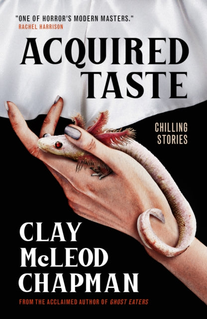 Acquired Taste book cover featuring a hand holding a salamander.