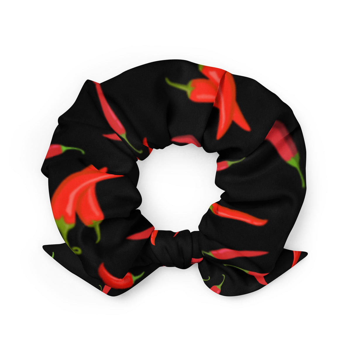 A black scrunchie with a red chili pepper pattern and a bow.