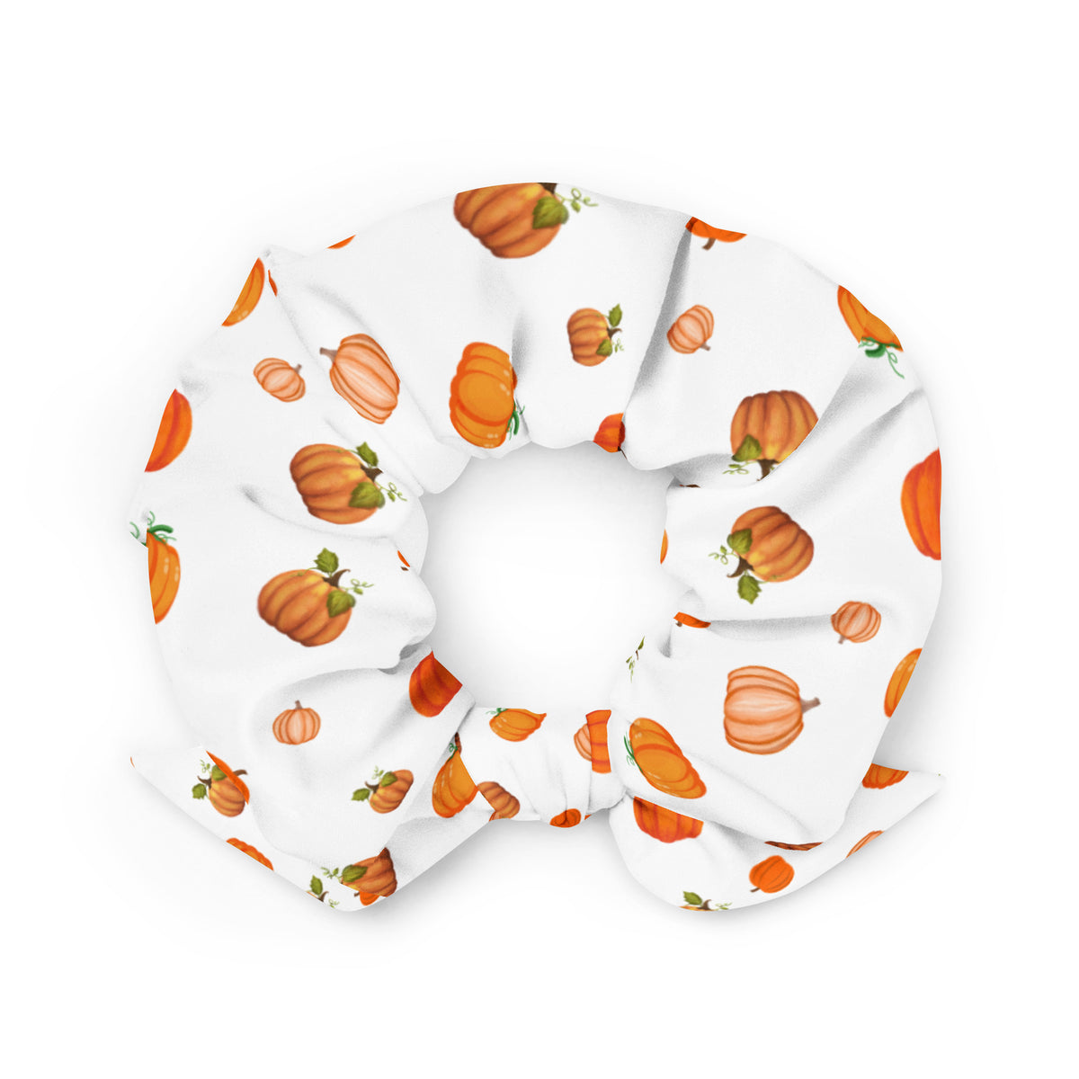 A white scrunchie with a pattern of orange pumpkins.