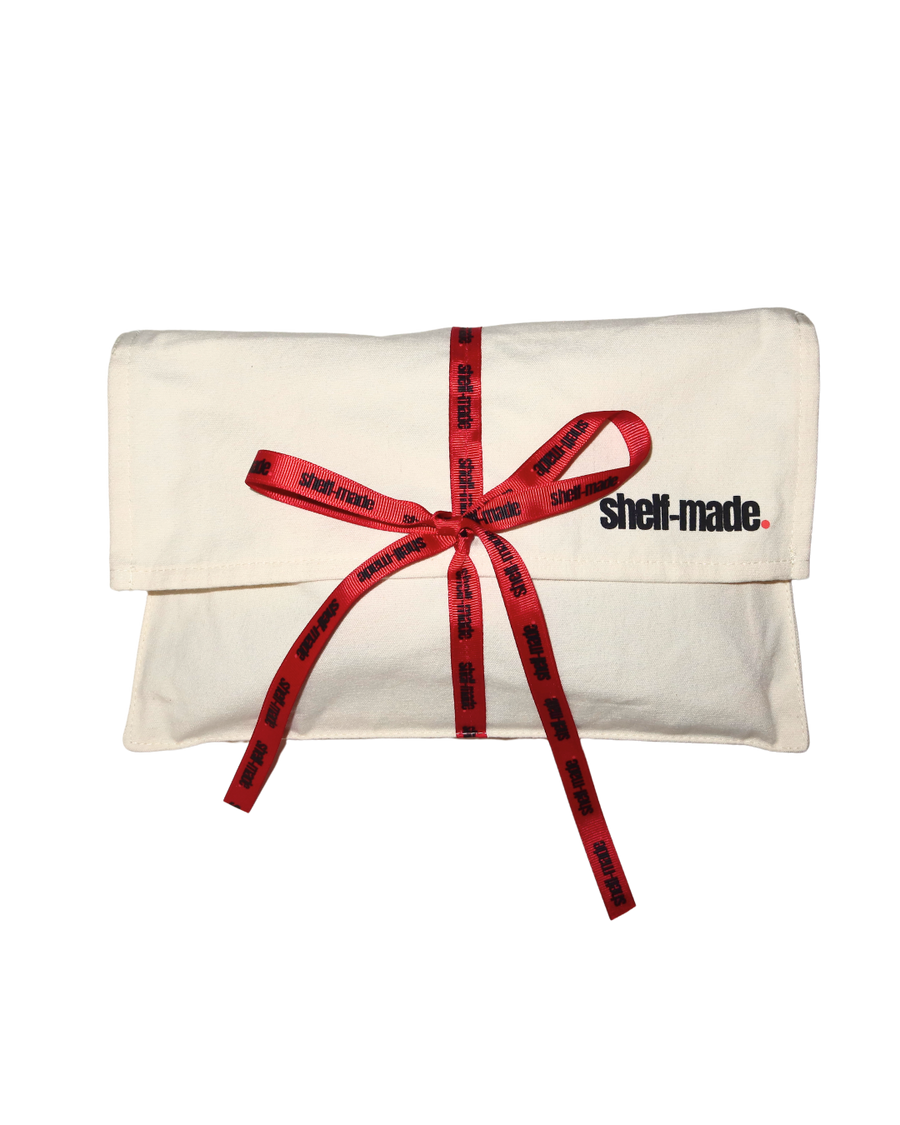 Shelf Made canvas pouch tied with branded red ribbon