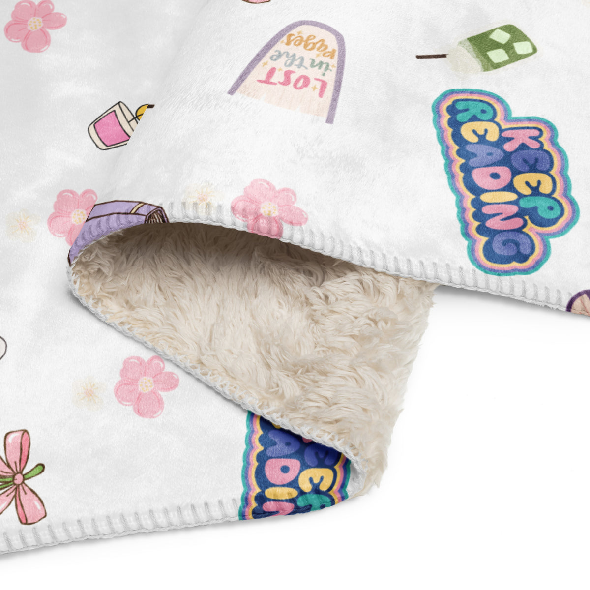 Cozy Club Bookish Sherpa blanket with pink flowers and reading-themed graphics.