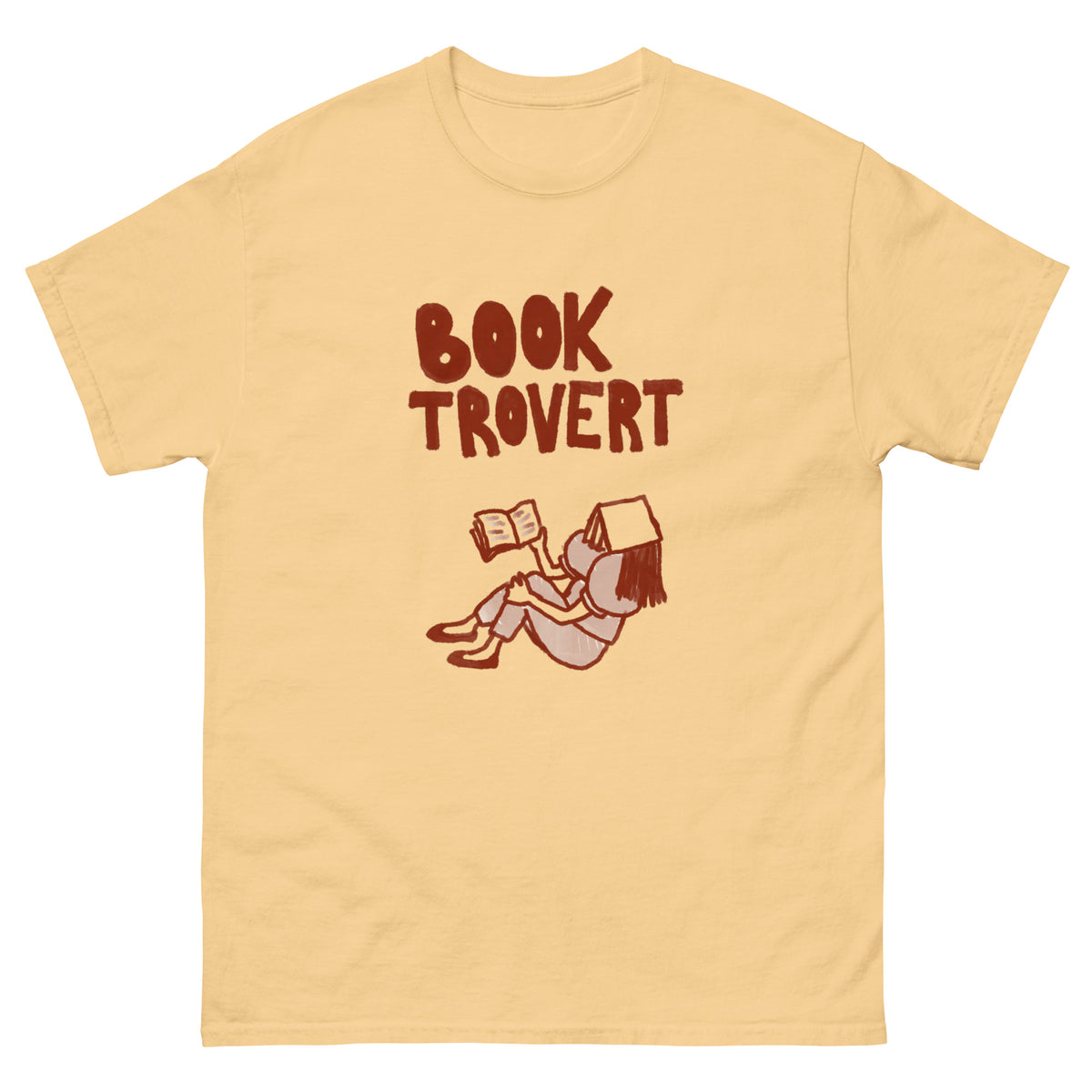 A light yellow t-shirt with the words "BOOK TROVERT" and a drawing of a person reading.