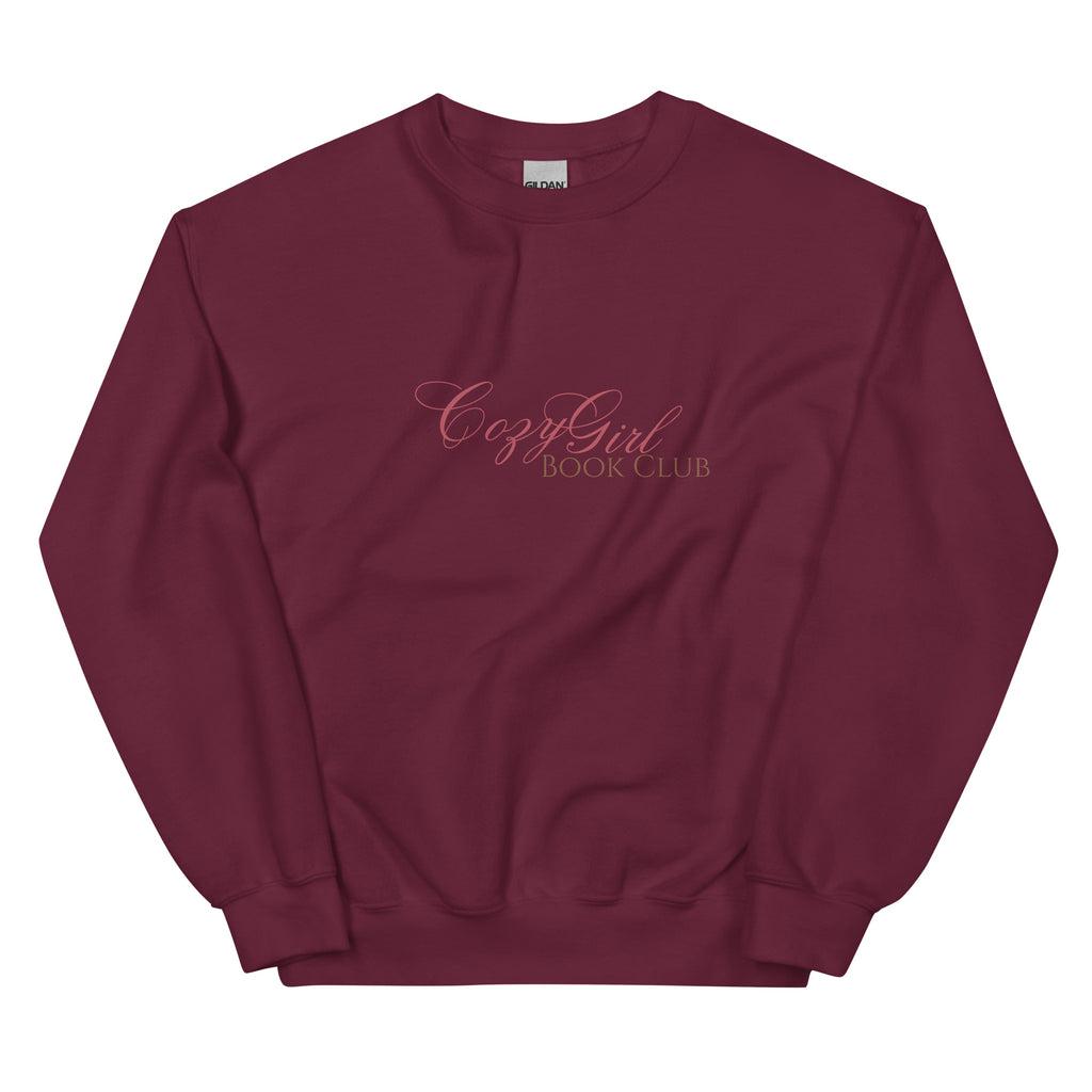 Maroon sweatshirt with "Cozy Girl Book Club" embroidered in pink.