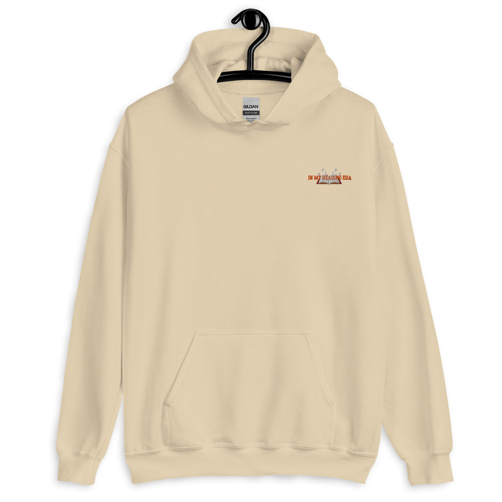 A beige Gildan hoodie with "In My Reading Era" text and an open book graphic.