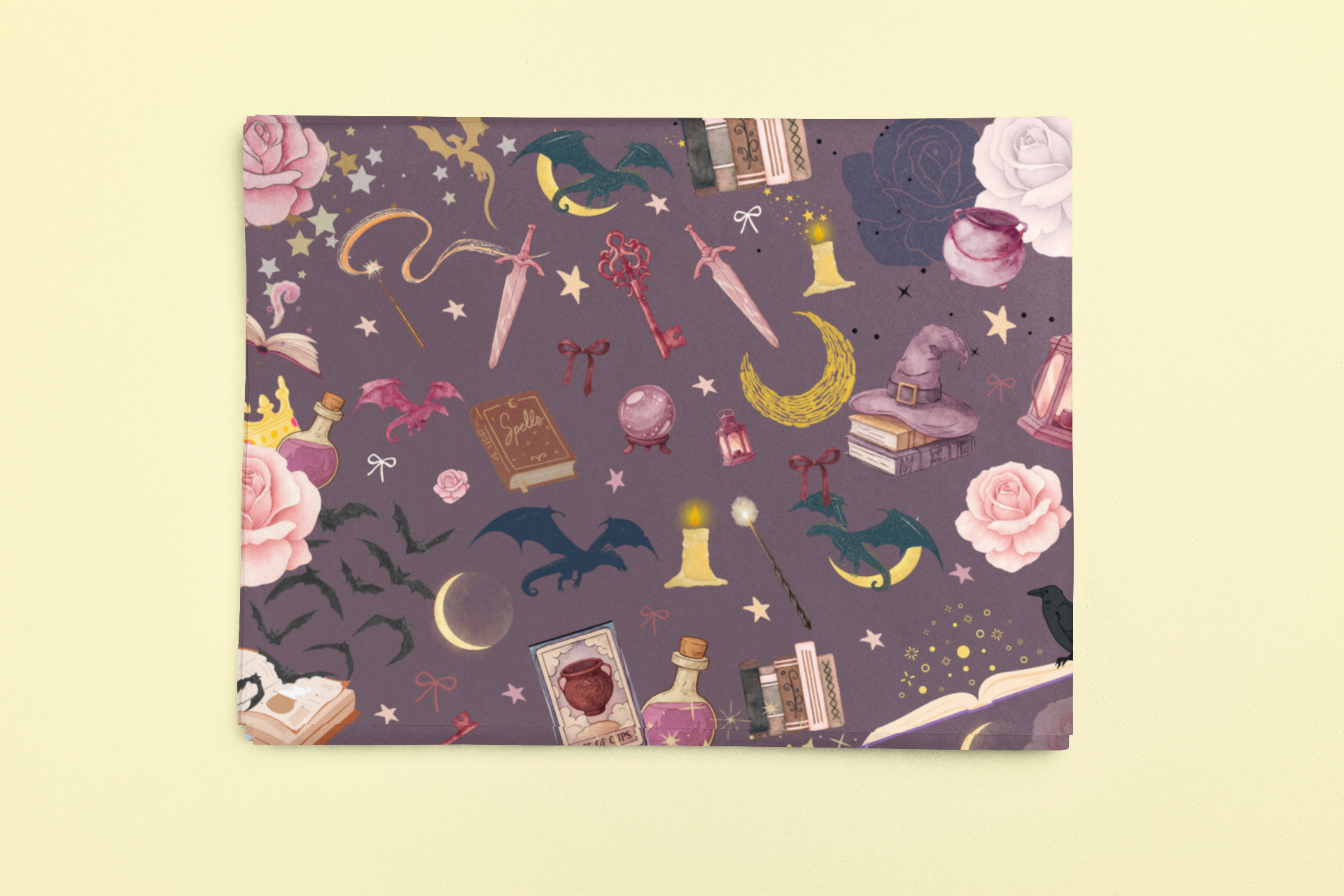Romantasy bookish wrapping sheets with a magical pattern of dragons, roses, and spell books.