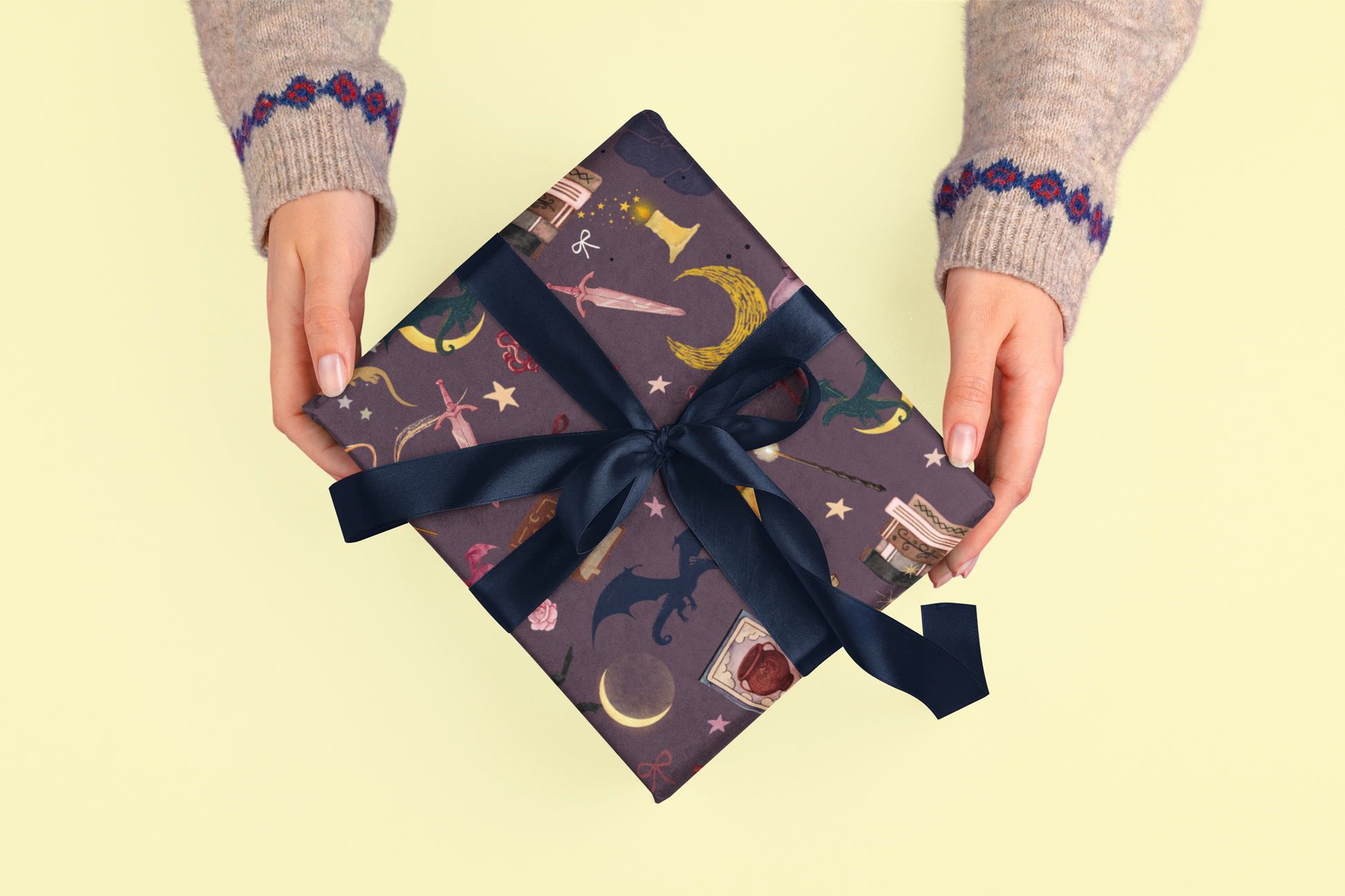 Romantasy bookish wrapping sheets with a dark, patterned design and navy ribbon.